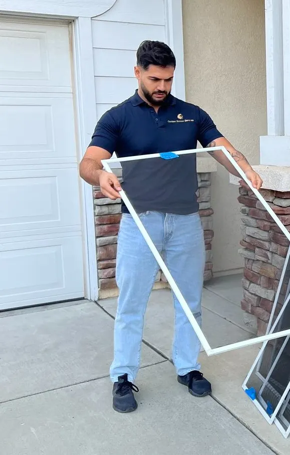 Mahammad, owner of Golden Screen Services, holding a freshly built screen frame
